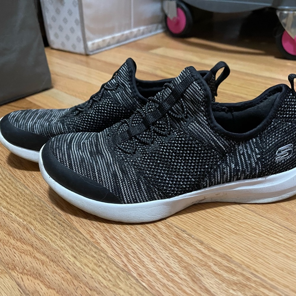 Women’s sketcher’s air cooled memory foam Slip on Sneakers in black and white.